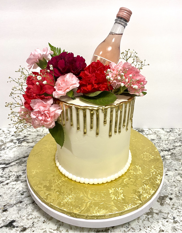 Picture of White fondant cake with Gold Drip and Pink & Red Carnations