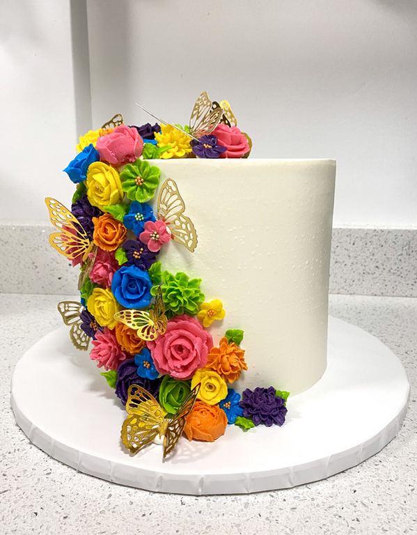 Picture of Colorful Buttercream Roses with Gold Butterflies on birthday cake