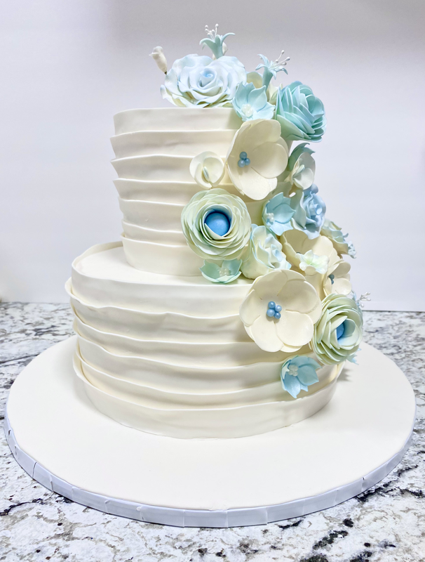 Picture of White and Blue Ruffle Wedding Cake with Gum Paste Flowers
